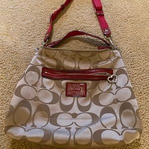 Coach shoulder bag, tan with red accents.
